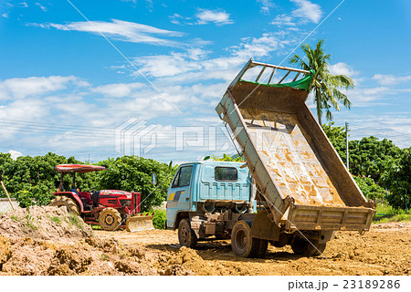 Dump truck unloading soil at construction site Dump truck unloading soil at construction site 23189286
