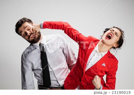 The angry business man and woman conflicting on a The angry business man and woman conflicting on a 23190019