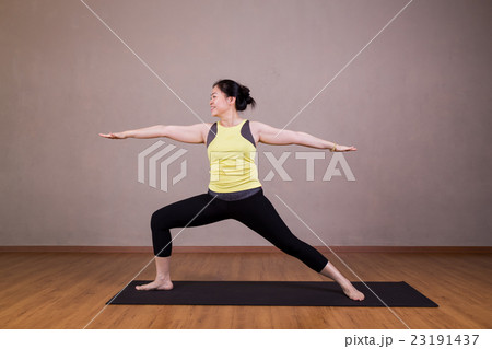 Female performing the Warrior 2 yoga pose 23191437