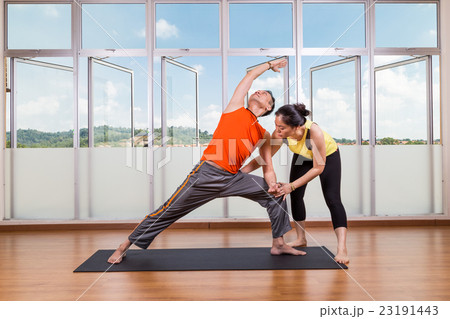 Yoga student perform extended side angle pose 23191443