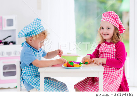 Kids playing with toy kitchen 23194365