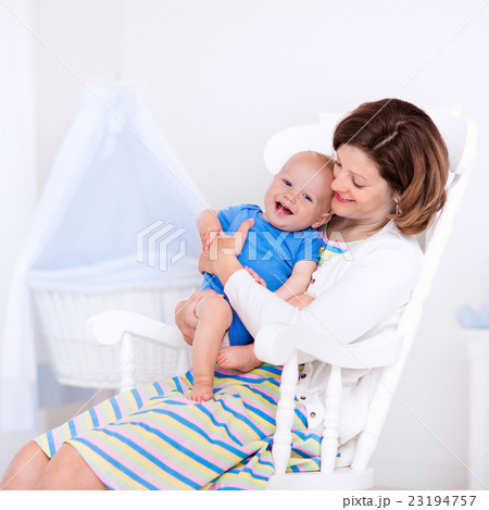 Mother and baby in white bedroom 23194757