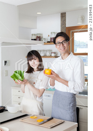 野菜を持つキッチンのカップル 23199483