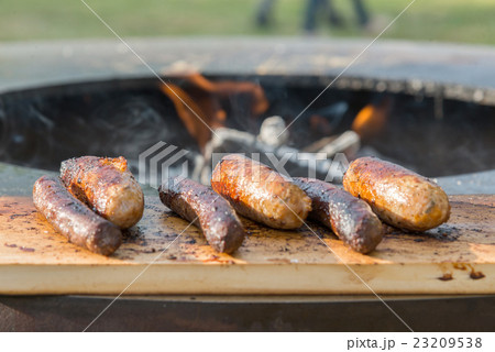 Grilling sausages on barbecue grill 23209538