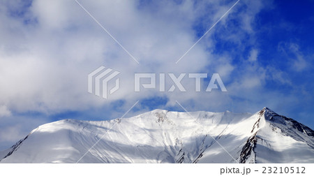 Panoramic view on off-piste snowy slope  wind day 23210512