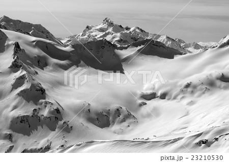 Black and white view on snowy peaks 23210530