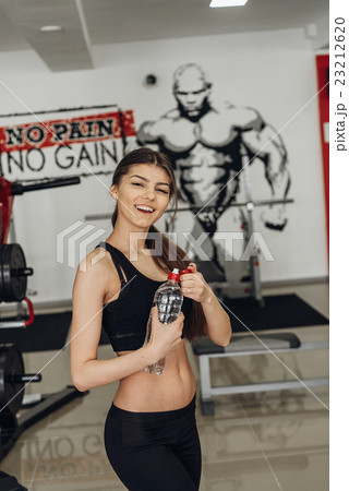 Beautiful girl with water at the gym Beautiful girl with water at the gym 23212620