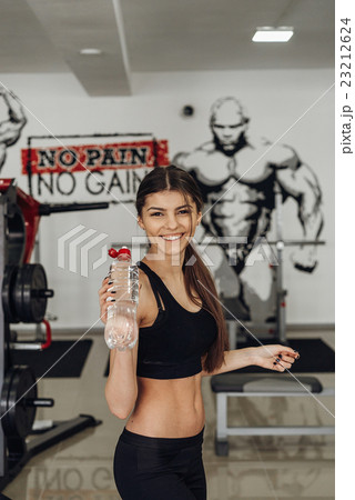 Beautiful girl with water at the gym Beautiful girl with water at the gym 23212624