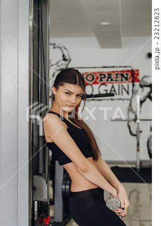 Beautiful girl with water at the gym Beautiful girl with water at the gym 23212625