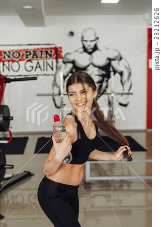 Beautiful girl with water at the gym Beautiful girl with water at the gym 23212626