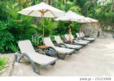 Sun bed beside swimming pool. Vintage filter. 23223908