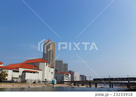 宝塚大劇場と武庫川を渡る阪急電車 23233918