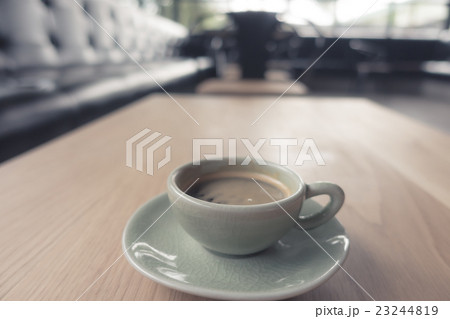Espresso Coffee cup on wood table . ( Filtered image processed vintage effect. ) Espresso Coffee cup on wood table . ( Filtered image processed vintage effect. ) 23244819