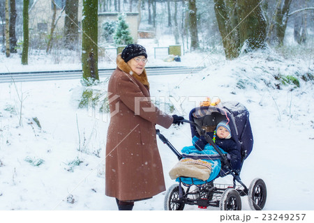 Grandmother walking with baby boy in winter Grandmother walking with baby boy in winter 23249257
