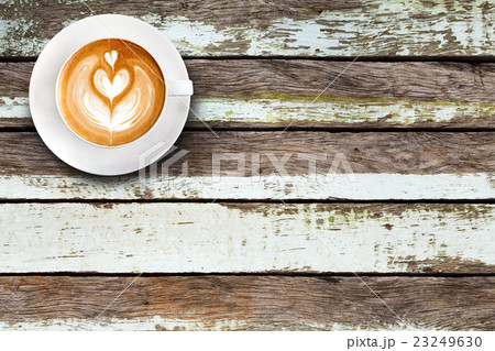 Top view latte art coffee on wood background. Top view latte art coffee on wood background. 23249630