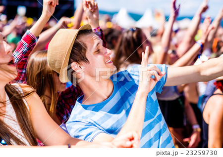 Teenagers at summer music festival enjoying 23259730