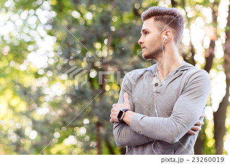 Pensive young sportsman resting after training 23260019