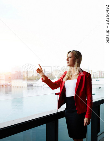 Successful woman standing on the balcony  23260492