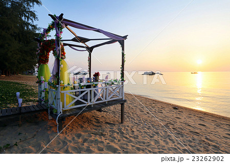 Romantic sunset beachside dinner  for couple 23262902