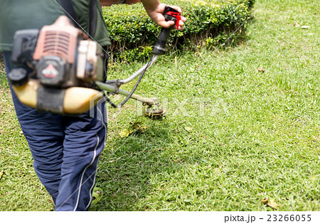 Gardener mowing the grass Gardener mowing the grass 23266055