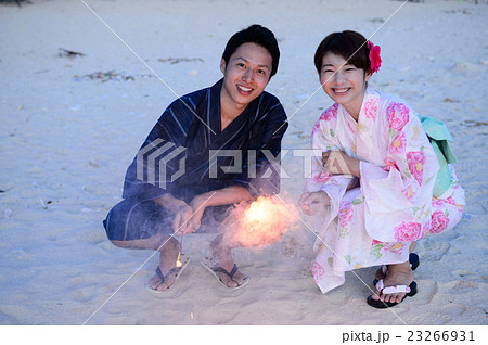 浴衣で花火をするカップルの写真素材