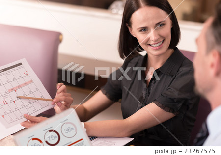 Positive colleagues sitting at the table 23267575