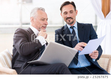 Pleasant professional colleagues sitting on the Pleasant professional colleagues sitting on the 23267875