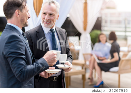 Pleasant smiling colleagues drinking coffee Pleasant smiling colleagues drinking coffee 23267916