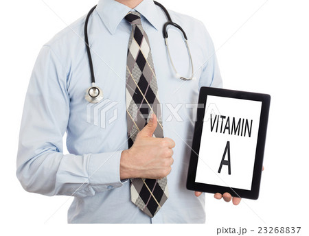Doctor holding tablet - Vitamin A Doctor holding tablet - Vitamin A 23268837