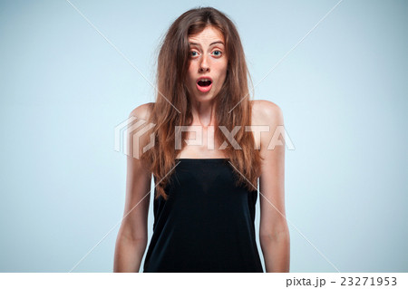 Portrait of young woman with shocked facial 23271953