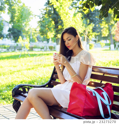 Beautiful brunette girl writing a message phone Beautiful brunette girl writing a message phone 23273270