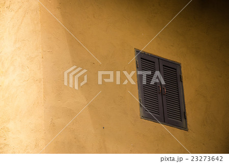 Orange wall with brown close window 23273642