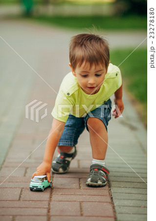 little boy playing with toy car 23278180