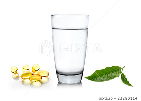 Glass of water wiith green tea leaf and fish oil  23280114