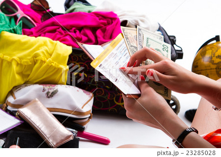 Hands holding dollars and ticket. 23285028