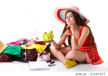 Lady sits beside overfilled suitcase. Lady sits beside overfilled suitcase. 23285057