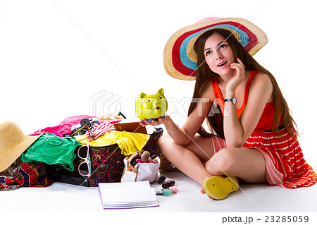 Girl beside overfilled suitcase. 23285059