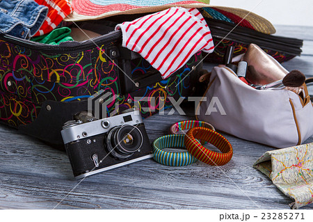 Camera near suitcase with clothes. Camera near suitcase with clothes. 23285271
