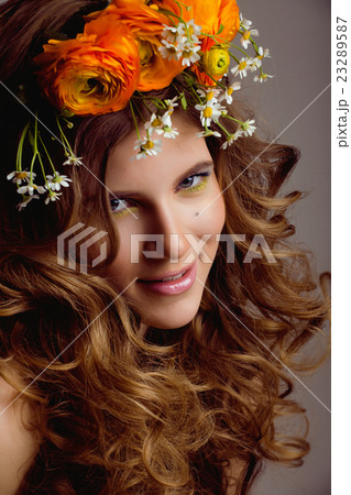 Beauty young woman with flowers and make up close 23289587