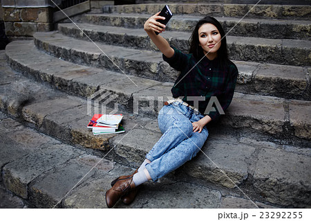 Charming girl smiling while taking a self-ie  23292255