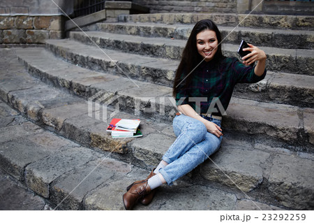 Hipster girl photographing herself with phone Hipster girl photographing herself with phone 23292259
