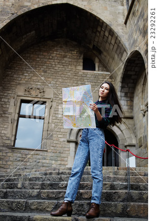 Young female tourist studying a map Young female tourist studying a map 23292261