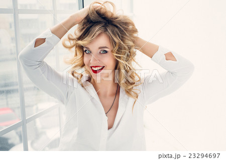 Girl smiling at camera in a white shirt 23294697