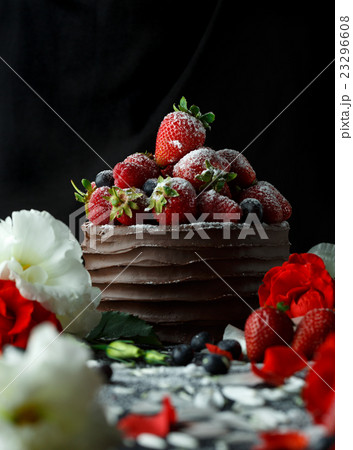 Rpe strawberries in a chocolate cake on a black Rpe strawberries in a chocolate cake on a black 23296608