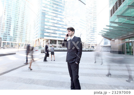 Businessman talking on cellphone Businessman talking on cellphone 23297009