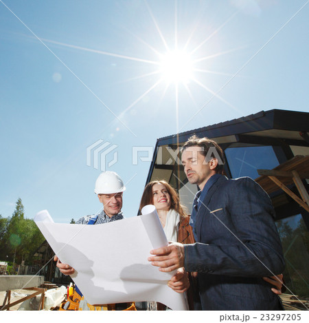 Worker shows house design plans 23297205