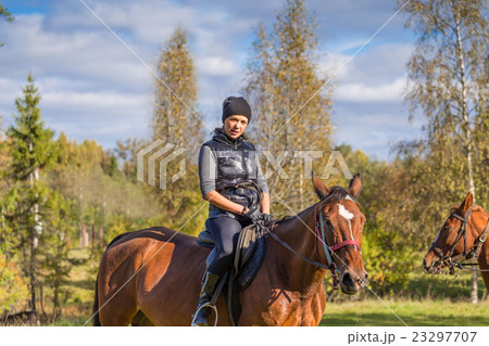 Elegant attractive woman riding a horse meadow Elegant attractive woman riding a horse meadow 23297707