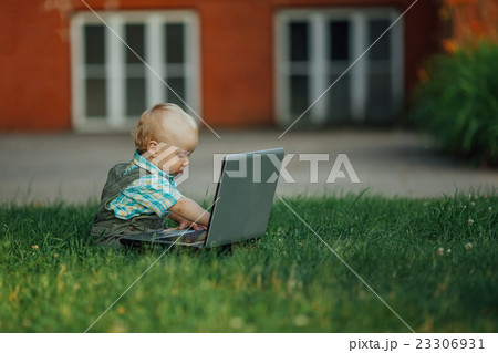 little boy with laptop on grass little boy with laptop on grass 23306931