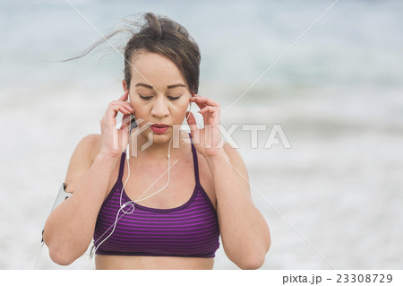 Female runner preparing for outdoor workout on the Female runner preparing for outdoor workout on the 23308729