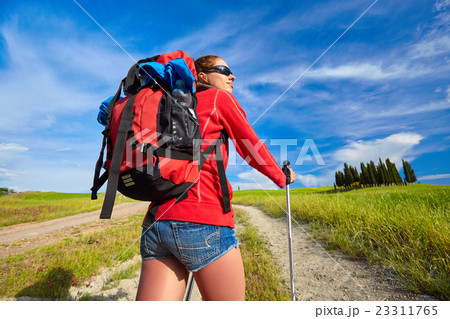 Tourist girl enjoying view of beautiful dry green wheat hills Tourist girl enjoying view of beautiful dry green wheat hills 23311765